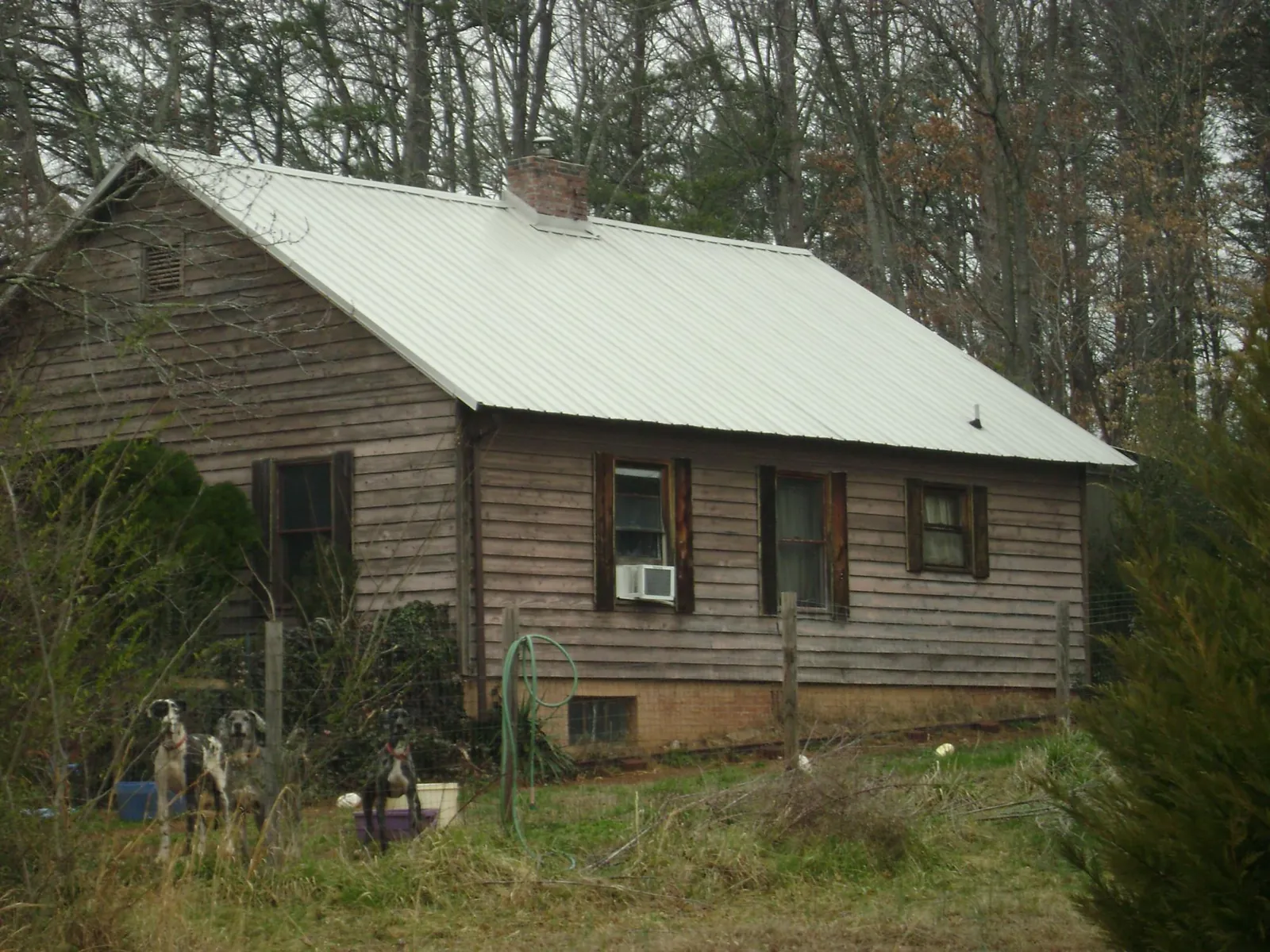 White metal roof on an old wood sided farmhouse, from a Asphalt Shingle Roof Repair job in Grahamsville